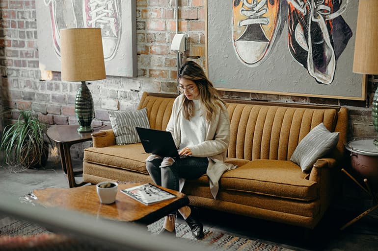 Woman working on couch